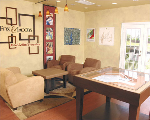 The Fox & Jacobs sales office with three lounge chairs surrounding a small table