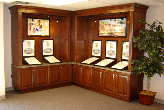 A custom wood cabinet displaying house floorplans and elevations