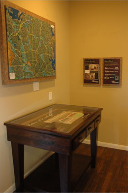 A large rectangular site map table with three drawers